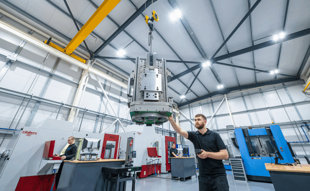 SyBridge Employee Lifting an Injection Molding Tool with a pully